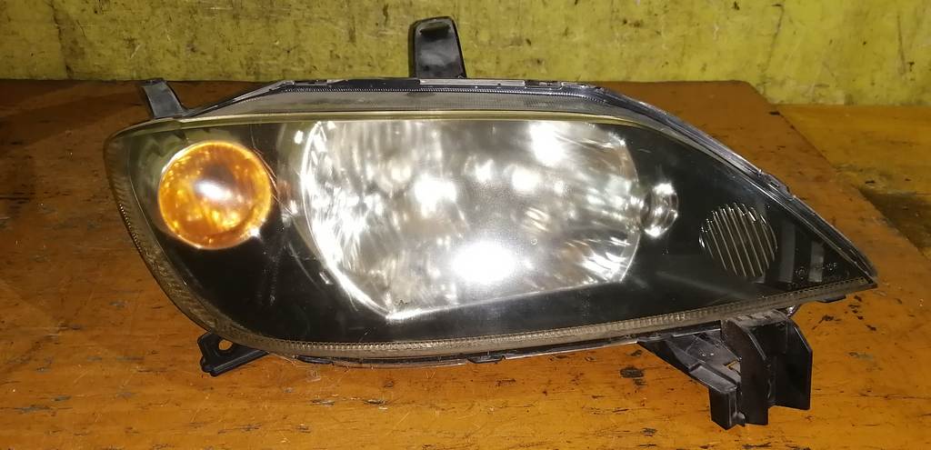 фара Mazda Demio