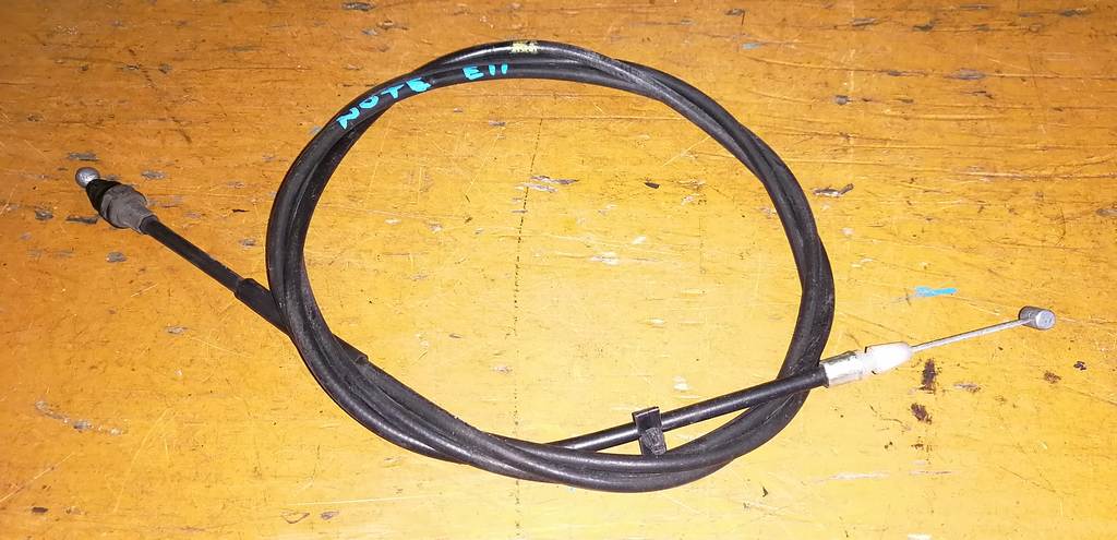 трос капота Nissan Note