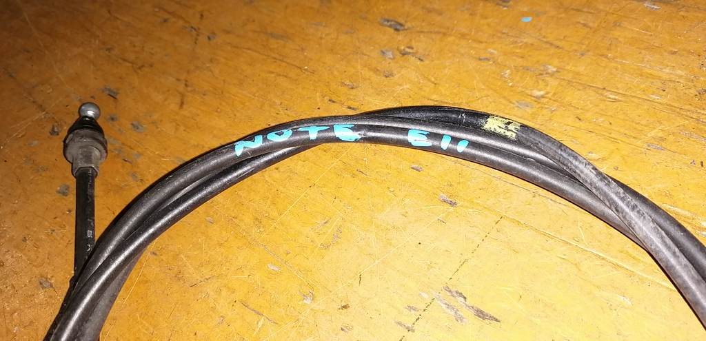 трос капота Nissan Note