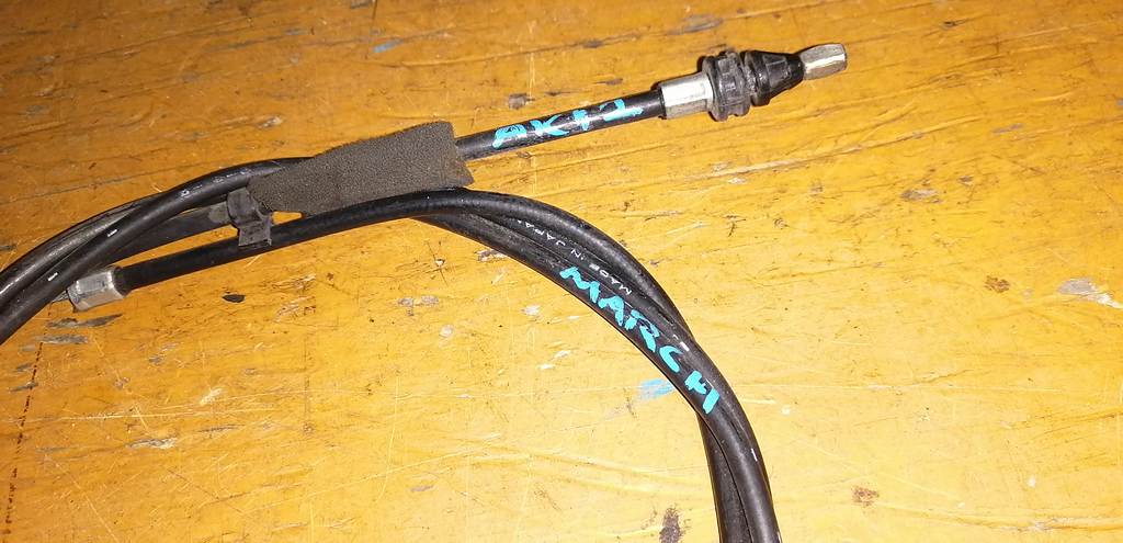 трос капота Nissan March